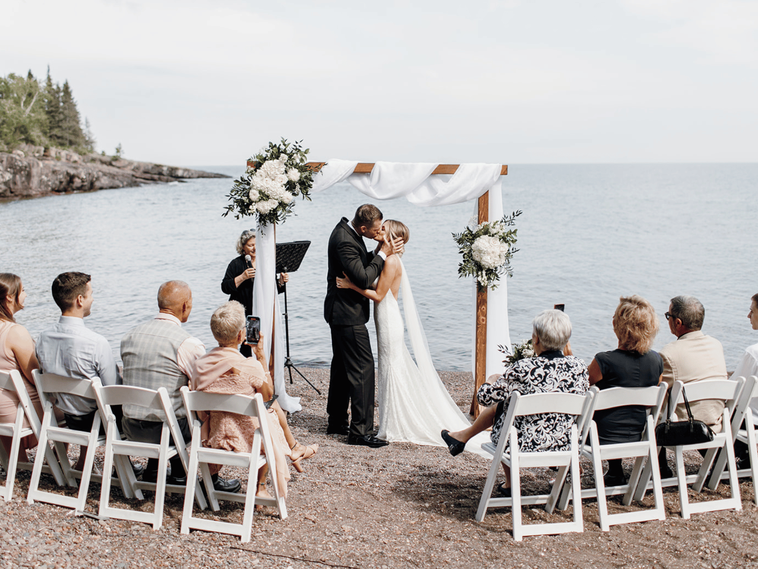 Couple kissing by the sea near Bluefin Bay Family of Resorts