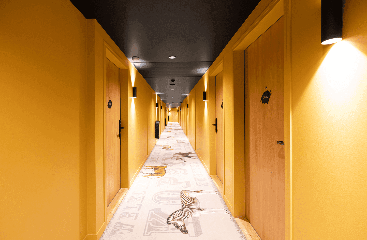 Hallway with orange interior at Kopster Hotel Paris Ouest Colombes