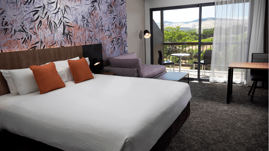 Interior of Comfy bedroom with a balcony at Novotel Barossa