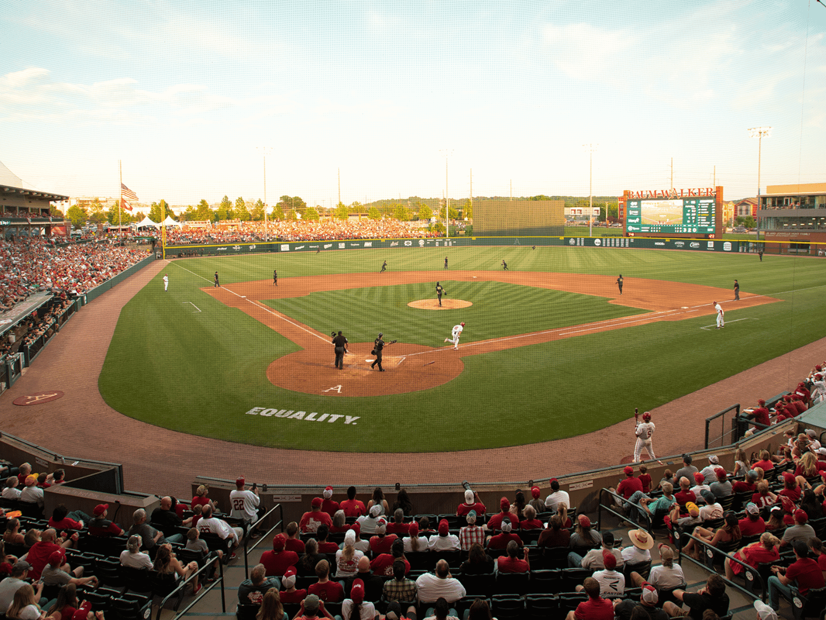 A baseball game in progress, players on field, spectators in stands,