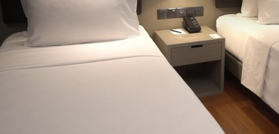 Twin beds in the Deluxe Suite at VE Hotel & Residence