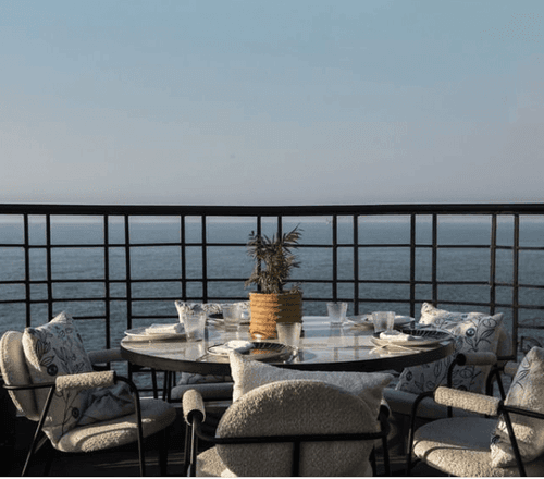 Dining table arrangements on a balcony in Em Sharif overlooking the ocean at Warwick Palm Beach Hotel - Beirut