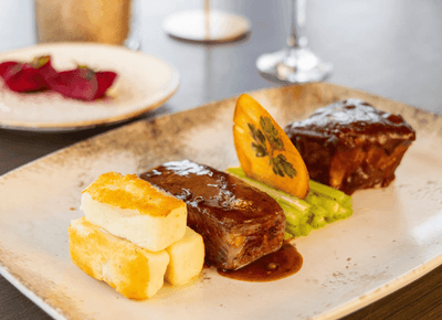 Gourmet steak dish with grilled asparagus and potato blocks served fresh at the on-site dining room at Rodd Hotels & Resorts