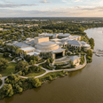 Aerial view of Riverside Theatre by a winding river and lush greenery near Star Suites Vero Beach under a cloudy sky
