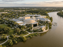 Aerial view of Riverside Theatre by a winding river and lush greenery near Star Suites Vero Beach under a cloudy sky