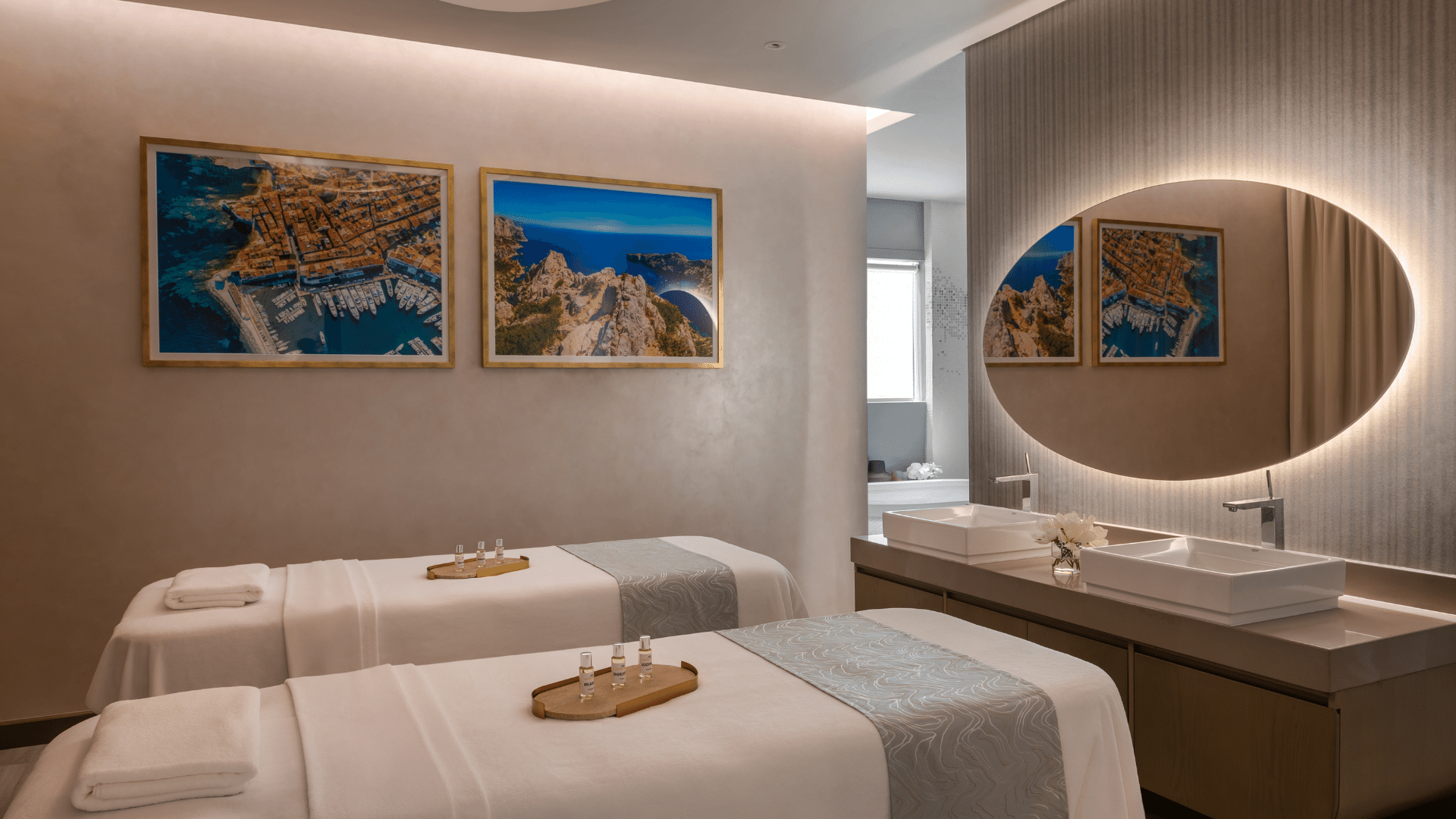 Serene spa treatment room featuring twin massage beds, modern sinks, and calming artwork at Paramount Hotel Midtown