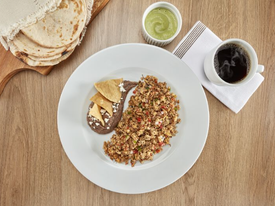 A dish served with a dip & a coffee by side, One Hotels