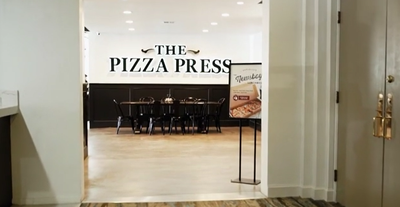 Entrance of the Pizza Press restaurant at Anaheim Hotel