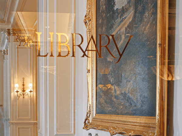 Library Bar logo with wall art at Warwick Melrose Dallas