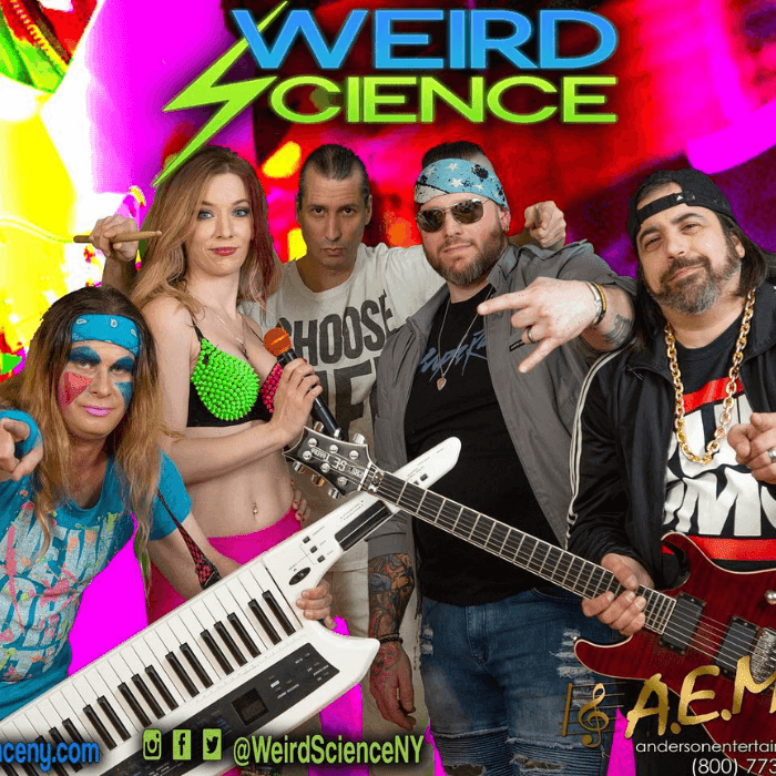 Weird Science Band at ICONA Windrift Avalon this Summer 5 bandmates dressed in colorful 80s attire with keyboard and guitar
