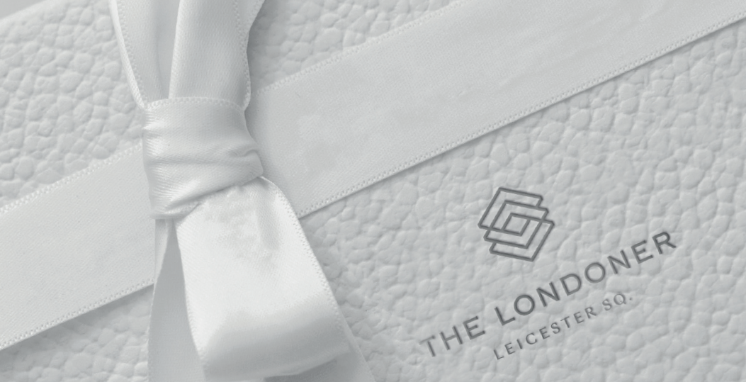 Close-up on a gift box with a white ribbon at Londoner Hotel