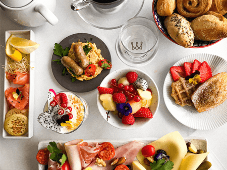 Brunch table with pastries, fruits & hot beverages at Warwick Brussels