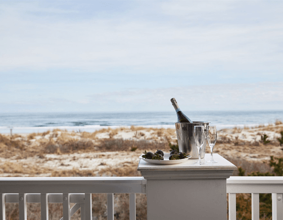 A bottle of champagne rests in a bucket of ice on the balcony in one of our Avalon hotel rooms