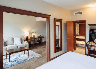 King Suite View with bedroom, separate living area, sofa, and work desk at Rodd Crowbush Golf & Beach Resort