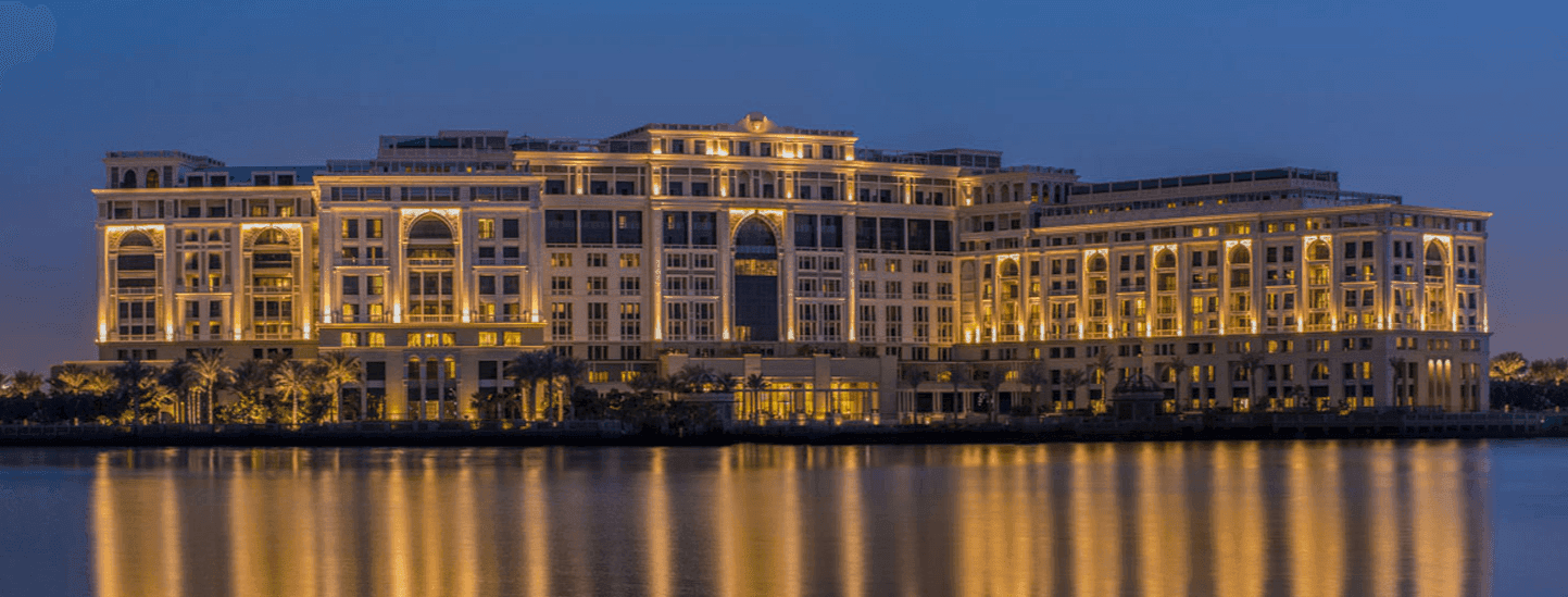 Exterior view of hotel by a river at night at Palazzo Versace