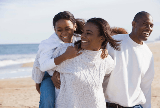 family laughing on beach