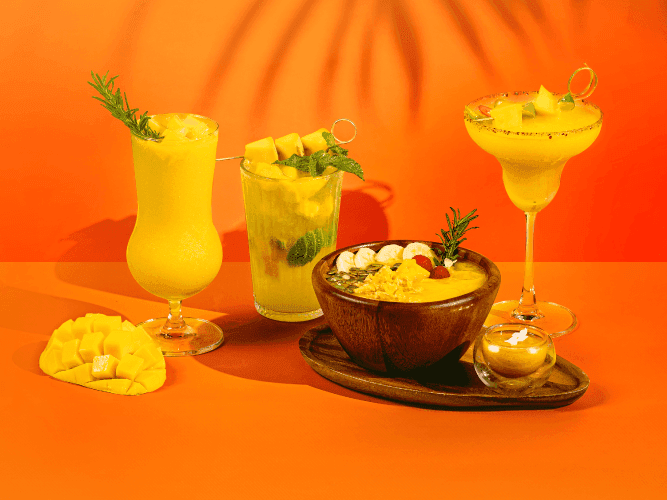 A table with three drinks: a refreshing soda, a fruity cocktail, and a tropical pineapple juice.