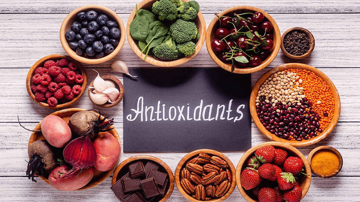 Bowls of fresh berries broccoli nuts and dark chocolate surrounding Antioxidants sign at Hotel X Toronto dining