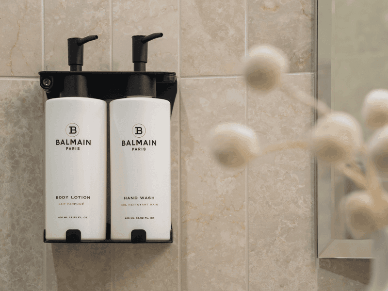 Luxury Balmain Paris Bathroom Amenities bottles displayed on marble counter surface