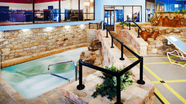 High angle view of the Indoor Hot Tub with a stone wall architecture at Cove Pocono Resorts