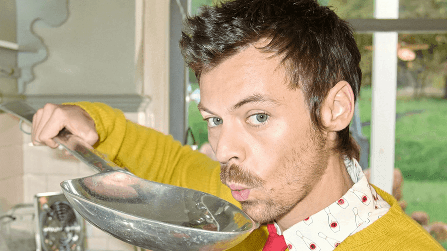 Man in a yellow sweater holding a large spoon at Harry Styles Together, Together Tour 2026.
