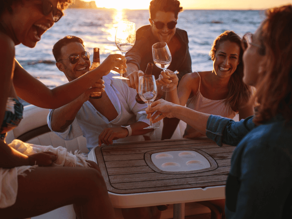 Group of people toasting on a boat during sunset near Bayside Inn Key Largo