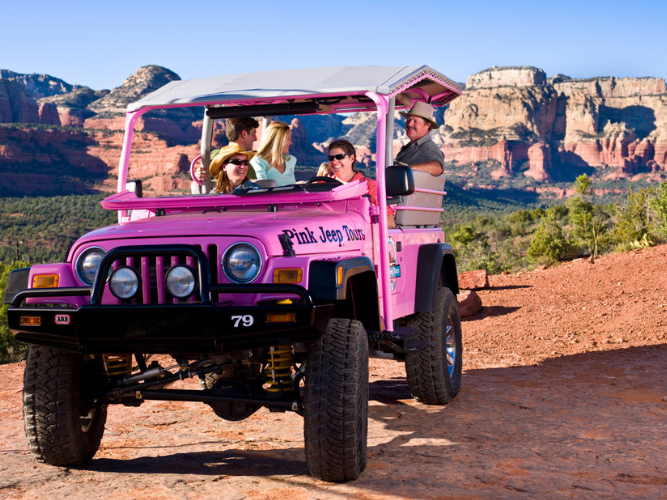 A group of people enjoying their ride in a jeep