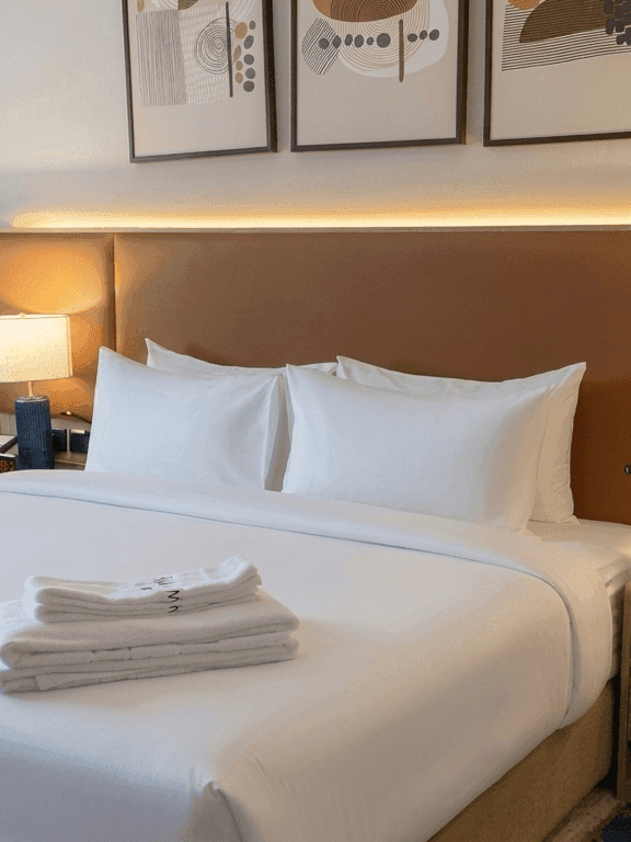 Accessible Room King with white linens, wooden headboard, and modern decor at Warwick Hotel & Spa - Jeddah
