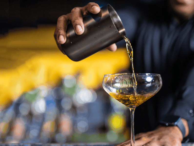 Close-up of pouring wine for glass in Blend Bar at Jamaica Pegasus Hotel