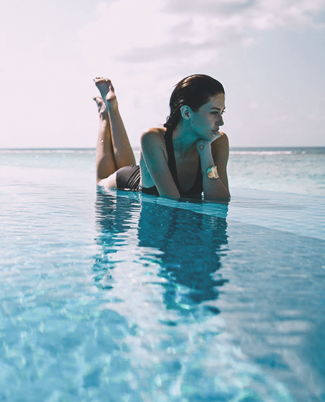 A lady relaxing on the pool edge  at The Signature Collection