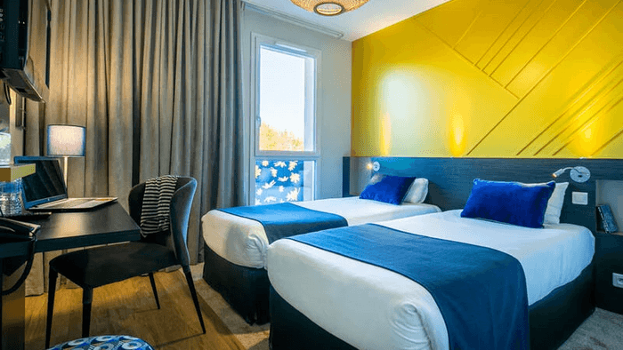 Twin beds at Hotel Saint James at The Originals Hotels