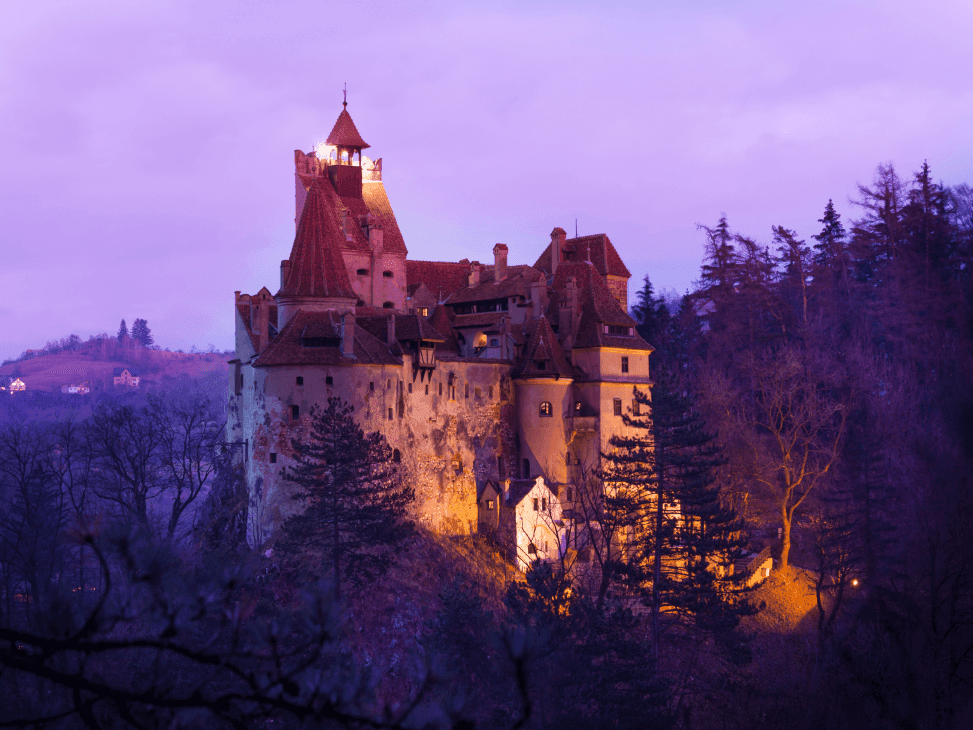Distant view of the Bran Castle in evening near Ana Hotels