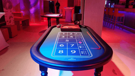 Illuminated digital craps table in a casino with red and blue lighting at Starling Hotel Lausanne