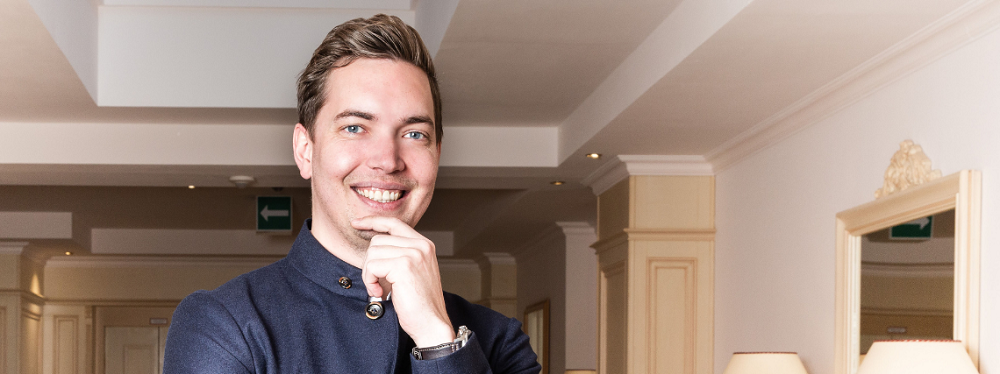 A young chef posing in a hallway at Hotel Liebes Rot Flueh