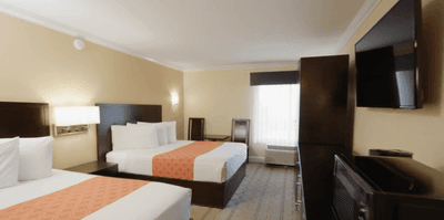 TV facing bed in Double Queen Room at Galleria Palms Hotel, a simple, clean hotel near Disney for park-focused trips