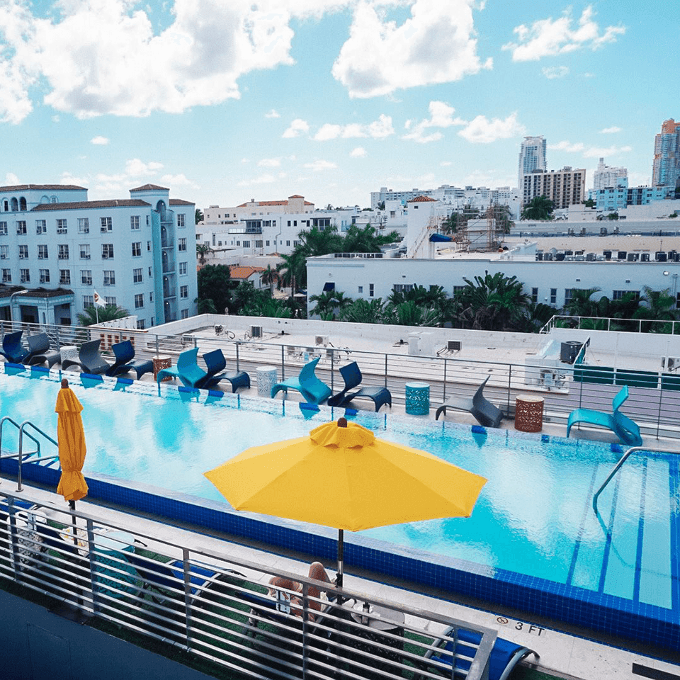 Aerial view of the Rooftop Pool with sun loungers and sun huts at Fairwind Hotel Miami