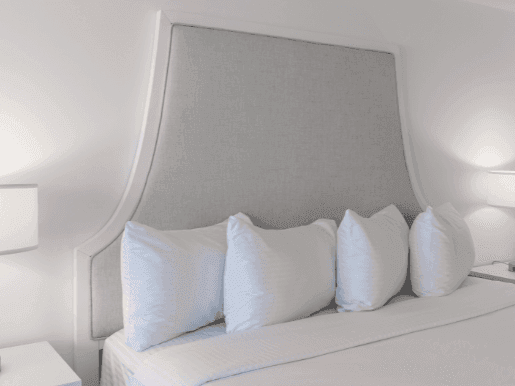 Interior of Signature King Room with big white king bed at ICONA Windrift