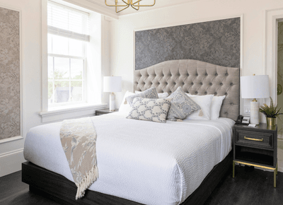 Tufted headboard bed in a bright room at Rodd Charlottetown hotel, perfect for Charlottetown accommodations