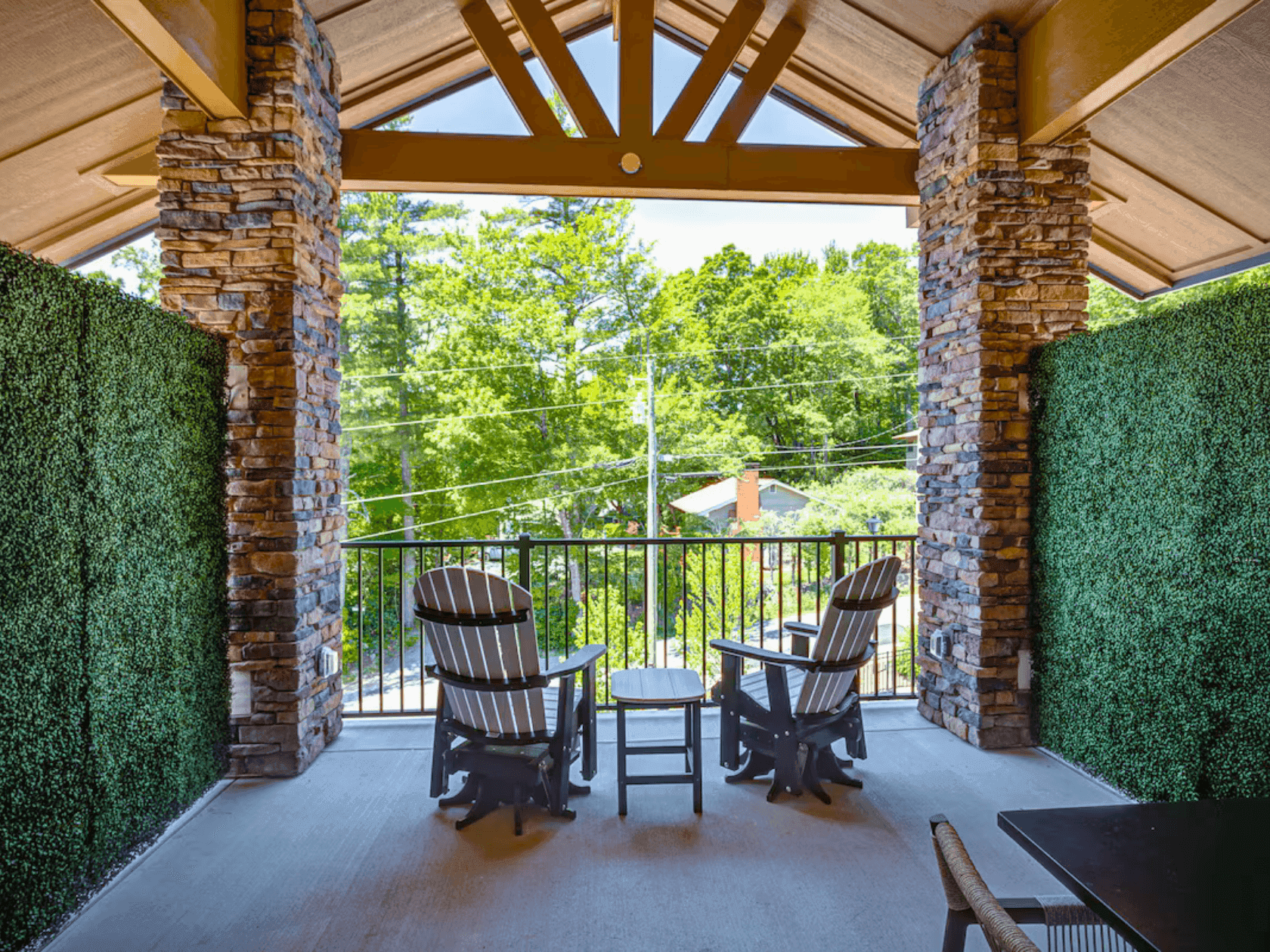 Two chairs and table on a balcony with greenery and trees in the background, Hello Spring, 25% Off.