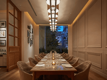 Opera dining room with a long wooden table, elegant chairs, and framed art at Park Hyatt Saigon