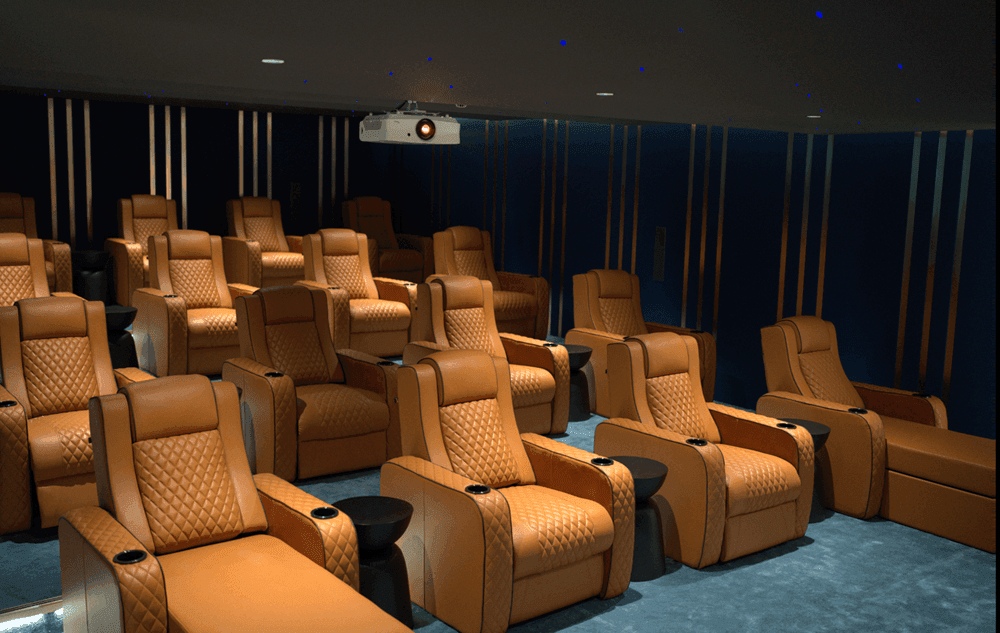 Luxurious leather recliner seats arranged in a stylish Movie Lounge room under modern lighting at DAMAC Maison Aykon City