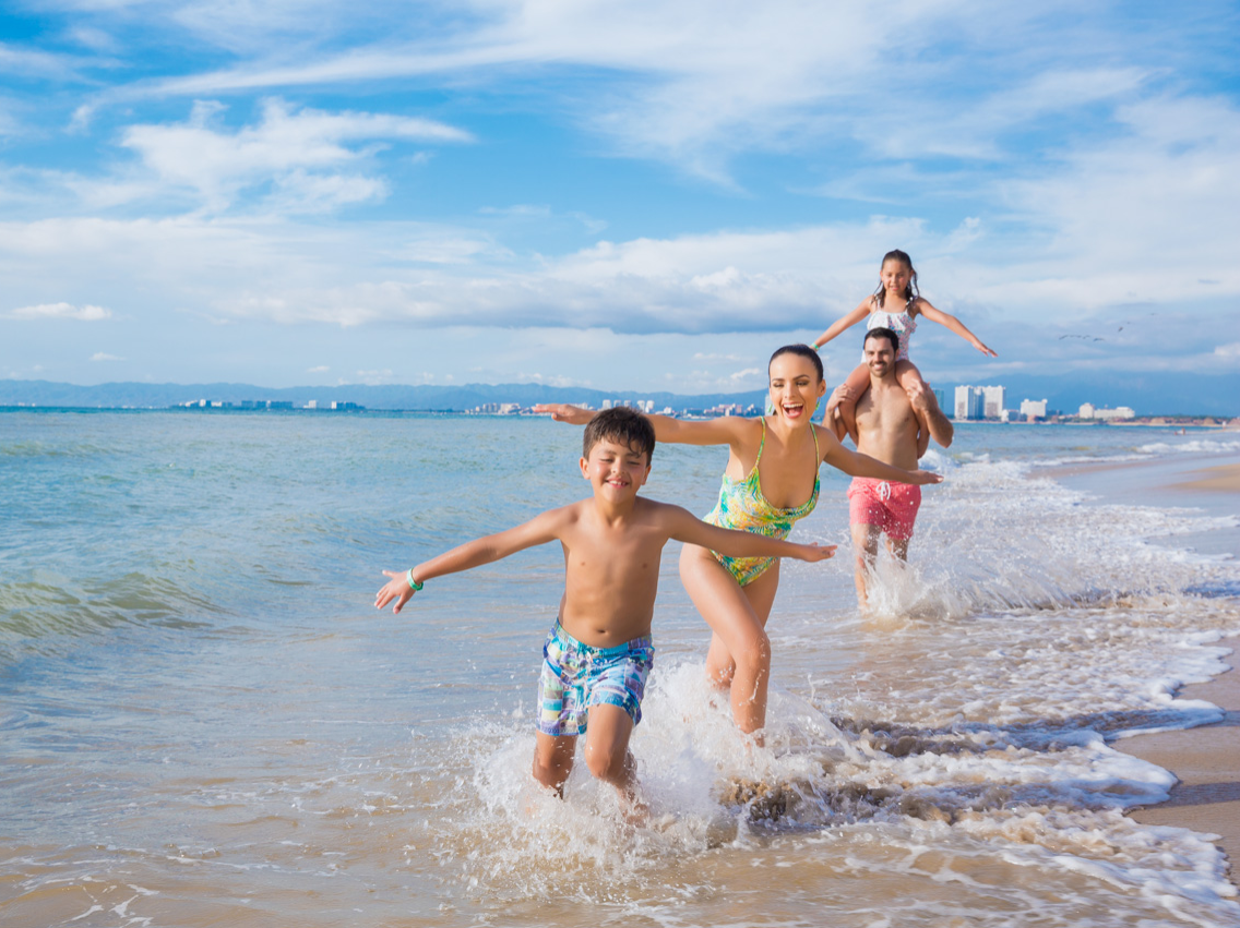 Family enjoying in the beach at Playa Los Arcos