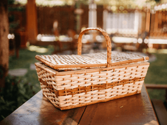 Picnic basket on a wooden table in outdoor of the inn at Willow grove