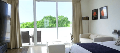 Bed & lounger in Town Master Suite at Playa Blanca Beach Resort