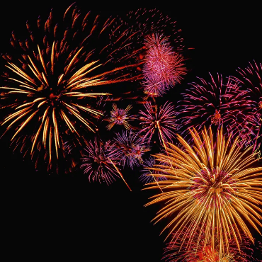 Bursting colorful fireworks display at night for Two Harbors Fireworks Voyage.