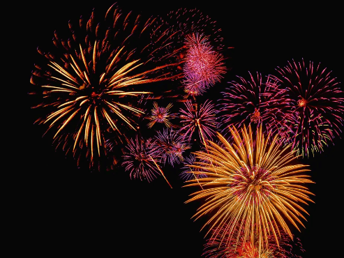 Bursting colorful fireworks display at night for Two Harbors Fireworks Voyage.