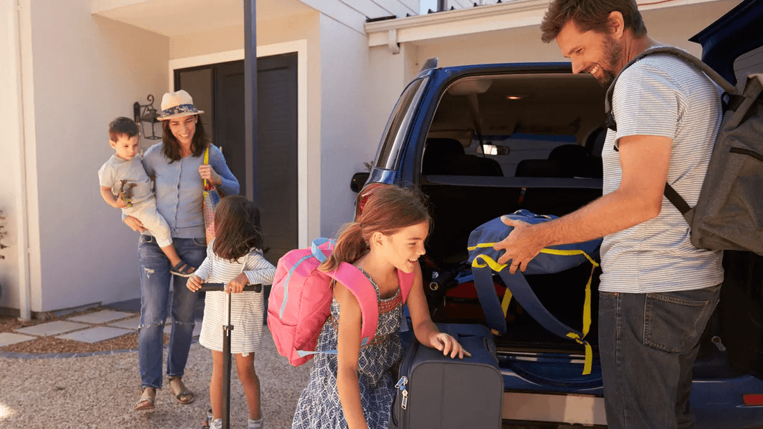 Smiling family with two kids loading luggage into a car at Novotel Sydney International Airport