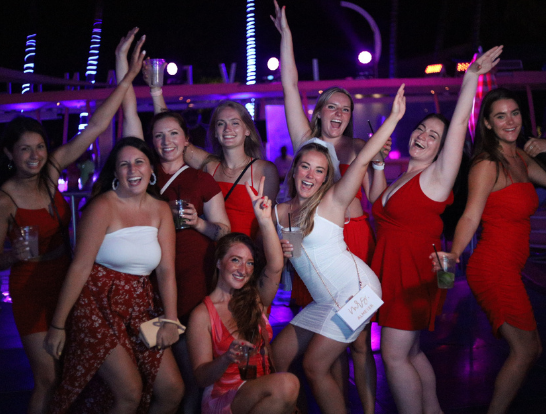 Girls posing to photo at night party at Clevelander South Beach