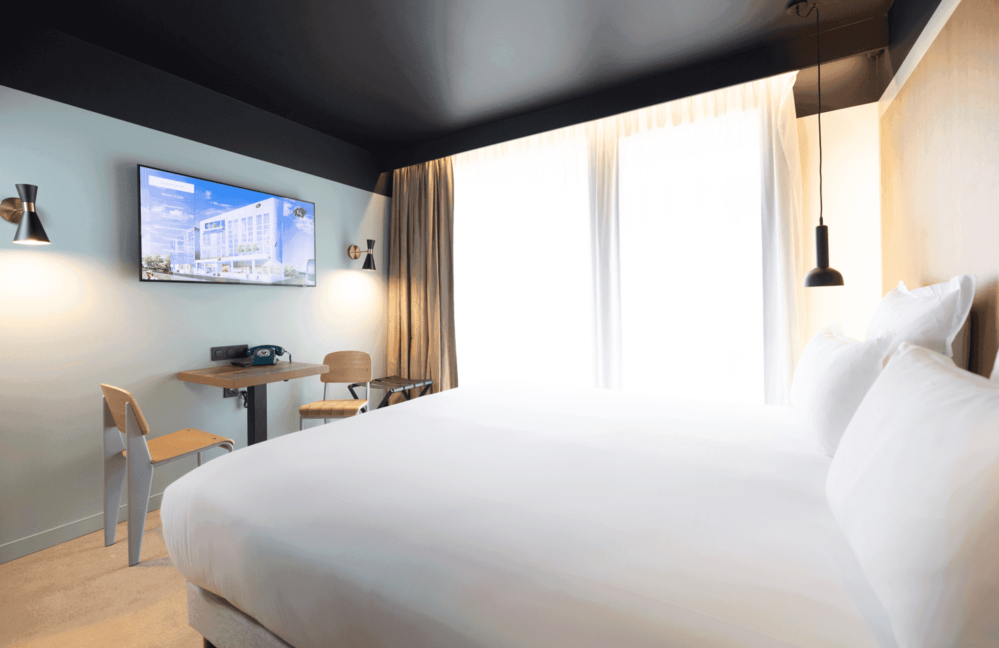 Large bed & TV in Studio Room at Kopster Hotel Paris Ouest Colombes