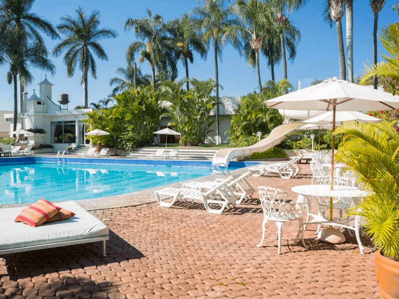 Sunbeds by the outdoor pool at Fiesta Americana Travelty